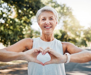 Lady makes shape of heart with her hands