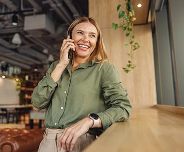 Lady smiles while speaking on phone