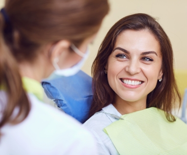 Dentist showing patient X-ray of their teeth