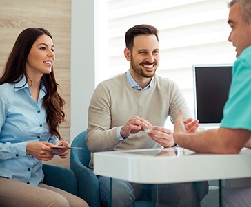 Couple discusses matters with dentist