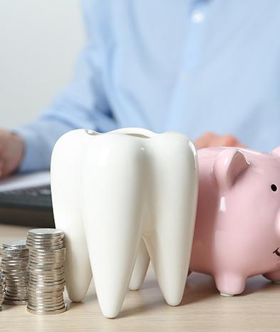 Coins next to a piggy bank