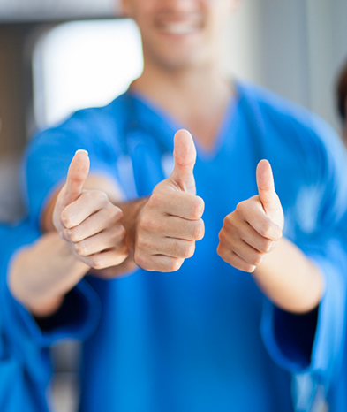Close-up of dental team giving a thumbs up