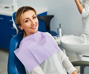 Patient smiling while sitting in treatment chair