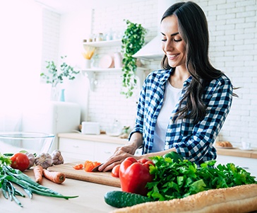Woman preparing vegetables in kitchen