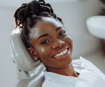 Woman smiling while sitting in treatment chair