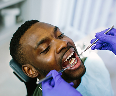 Male patient opening mouth for dental examination